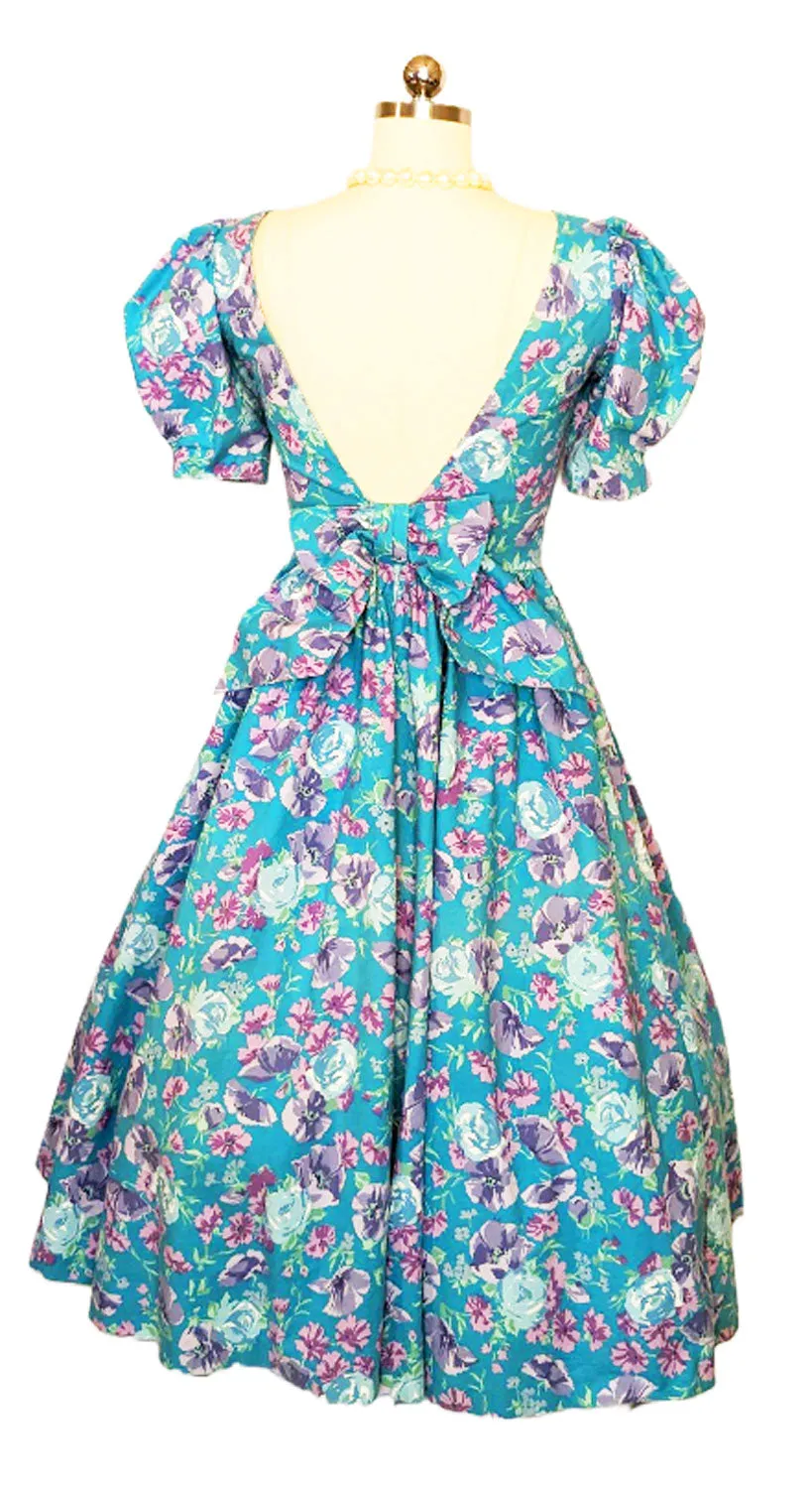 *   VINTAGE LAURA ASHLEY COTTON AQUA AND PURPLE FLORAL GORED GRAND SWEEP DRESS WITH BOW IN BACK MADE IN GREAT BRITAIN