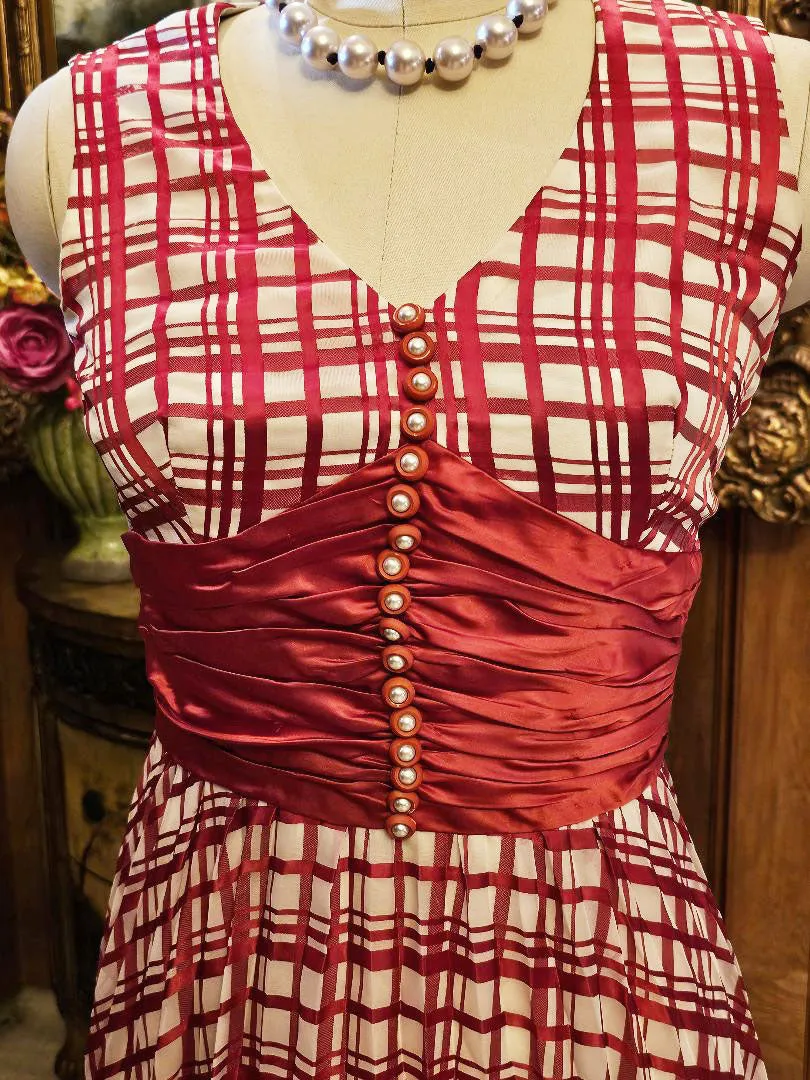 VINTAGE LATE 1960S EARLY 1970S RED AND WHITE PLAID PLEATED EVENING GOWN WITH RUCHED CUMMERBUND & PEARL BUTTONS